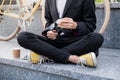 Stylish man in black suit and casual shoes cleaning his reading Royalty Free Stock Photo