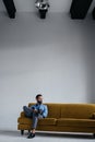 stylish man in blue trendy suit using smartphone and sitting Royalty Free Stock Photo