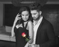 Stylish man give rose to woman indoor Royalty Free Stock Photo