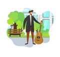 Stylish Man Holding Acoustic Guitar in Hand. Park. Royalty Free Stock Photo