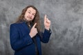 The stylish man with long hair in a striking blue suit posing in different stances Royalty Free Stock Photo