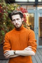 Stylish man in an orange turtleneck, portrait in an urban setting Royalty Free Stock Photo