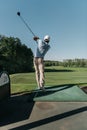 Stylish man playing golf alone at golf course Royalty Free Stock Photo