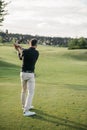 Stylish man playing golf on golf course at daytime Royalty Free Stock Photo