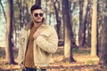 Stylish man posing in autumn park Royalty Free Stock Photo