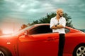 Stylish man with red sport car Royalty Free Stock Photo