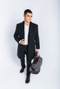 Stylish man in Studio on a white background, with a bag for travel, isolated, background, man goes on a journey Royalty Free Stock Photo