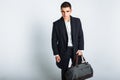 Stylish man in Studio on a white background, with a bag for travel, isolated, background, man goes on a journey Royalty Free Stock Photo