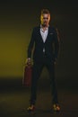 Stylish man in tuxedo standing and holding fire extinguisher Royalty Free Stock Photo