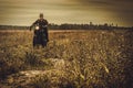 Stylish man on the vintage custom cafe racer in a field.