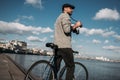 stylish man with vintage film camera and bike standing Royalty Free Stock Photo