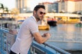 Stylish man wearing sunglasses and shirt. Handsome man outdoors portrait. Portrait of stylish male model outdoor