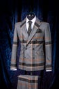 Stylish men`s gray check suit on a mannequin or dummy. Men`s Clothing. Clothing store. Shopping in boutiques