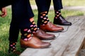 Stylish men`s socks. Stylish suitcase, men`s legs, multicolored socks and new shoes. Concept of style, fashion, beauty and Royalty Free Stock Photo