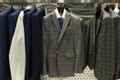 Stylish men`s suits in the store. Elegance and fashion. Close-up