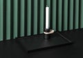 Trendy metal black tray with dark candlestick on folded green wall background