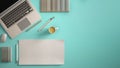 Stylish minimal office table desk. Workspace with laptop, notebook, pencils, coffee cup and sample color palette on pastel turquoi Royalty Free Stock Photo
