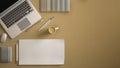 Stylish minimal office table desk. Workspace with laptop, notebook, pencils, coffee cup and sample color palette on pastel yellow