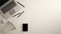 Stylish minimal office table desk. Workspace with laptop, notebook, pencils and sample color palette on white background. Flat lay