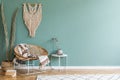 Boho interior design of living room with rattan armchair.