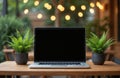 Stylish mockup featuring black laptop screen, surrounded by nature. Empty display for responsive website presentation. Workspace Royalty Free Stock Photo
