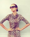 Stylish model woman posing in evening wearing dress with leopard print on city street Royalty Free Stock Photo