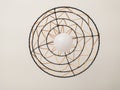 Stylish modern ceiling lamp with a unique woven design. The black wire frame and beige accents create a striking visual Royalty Free Stock Photo