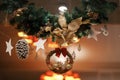 Stylish modern christmas wreath, branches, ornaments in lights in evening. Atmospheric magic time. Modern Christmas festive decor