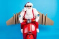 Stylish modern crazy white grey hair bearded santa claus with craft wings drive scooter x-mas christmas fast deliver Royalty Free Stock Photo