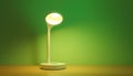 Modern desk lamp with green base on a table Generative AI