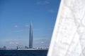 Stylish modern glass skyscraper building at seashore, yacht view