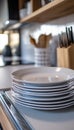 Stylish Modern Kitchen Interior Featuring Clean Plates Stack, Silverware Set, and Cooking Utensils Royalty Free Stock Photo