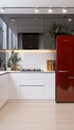 Stylish Modern Kitchen with Red Fridge, Elegant White Cabinets, and Contemporary Design Elements Royalty Free Stock Photo