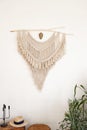 Stylish and modern living room interior in boho style with mockup photo frames, beige macrame and elegant accessories. Royalty Free Stock Photo