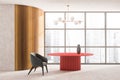 Stylish modern living room interior in skyscraper building with design armchair and red round table, cement floor. Futuristic Royalty Free Stock Photo