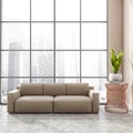 Stylish modern office room interior in skyscraper building with design beige leather couch, tile ceramic floor. Panoramic window. Royalty Free Stock Photo