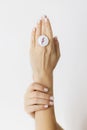 Stylish modern round ring on beautiful hands on white background. Unusual fused glass ring