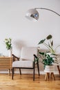 Stylish modern Scandinavian interior of living room with candles and fresh flowers on wooden console, retro style