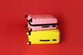 Stylish modern suitcases on color background
