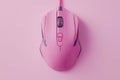 Stylish modern wired optical mouse elegantly positioned on a soft pink background from above Royalty Free Stock Photo