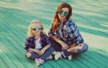 Stylish mother and child wearing a sunglasses, shirts in a city park Royalty Free Stock Photo