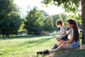 Stylish mother and toddler reading book at garden during summer fun Royalty Free Stock Photo