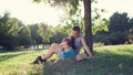 Stylish mother and toddler reading book at garden during summer fun Royalty Free Stock Photo