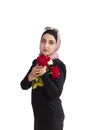 Stylish Muslim woman in traditional Islamic clothing holding flower bouquet. Portrait of beautiful middle-eastern girl in Hijab. Royalty Free Stock Photo