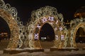 Stylish New Year\'s luminous clock and arch with garlands. Christmas city illumination on the central city square Royalty Free Stock Photo