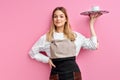 Stylish nice woman waitress in apron, offering cup of delicious tasty coffee