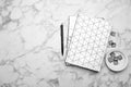 Stylish notebooks and pen on marble table, flat lay. Space for text