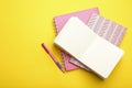 Stylish notebooks and pen on yellow background. Space for text Royalty Free Stock Photo