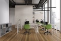 Stylish office coworking interior with desk and chairs in row, shelf and window Royalty Free Stock Photo