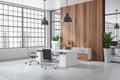 Stylish office interior with desk and armchair, decor and panoramic window